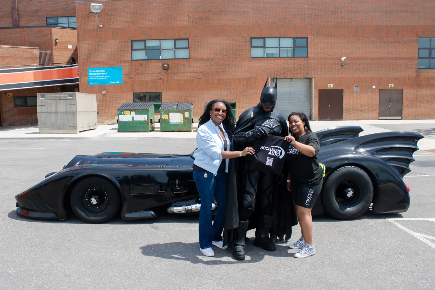 Participants beside a race car at Drive Forward