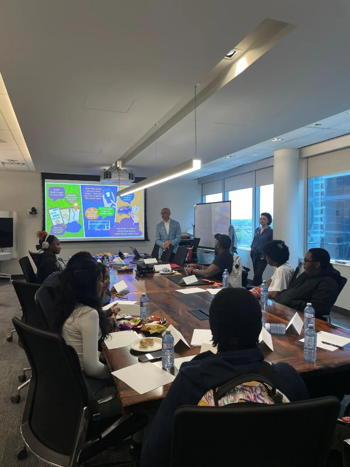 Students in a boardroom session at taq