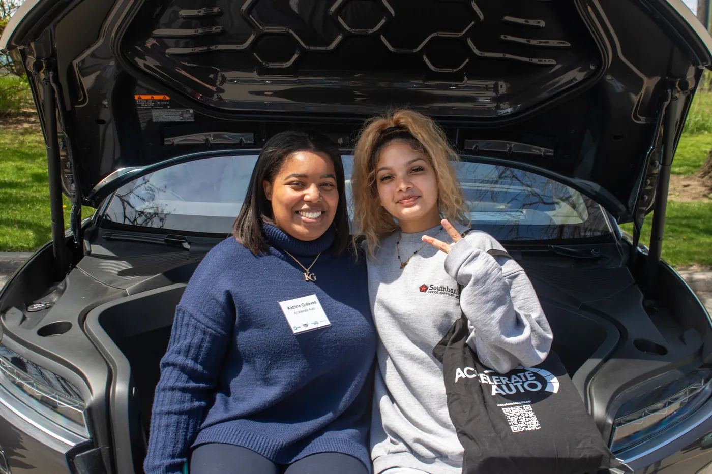 Students looking under the hood of a vehicle